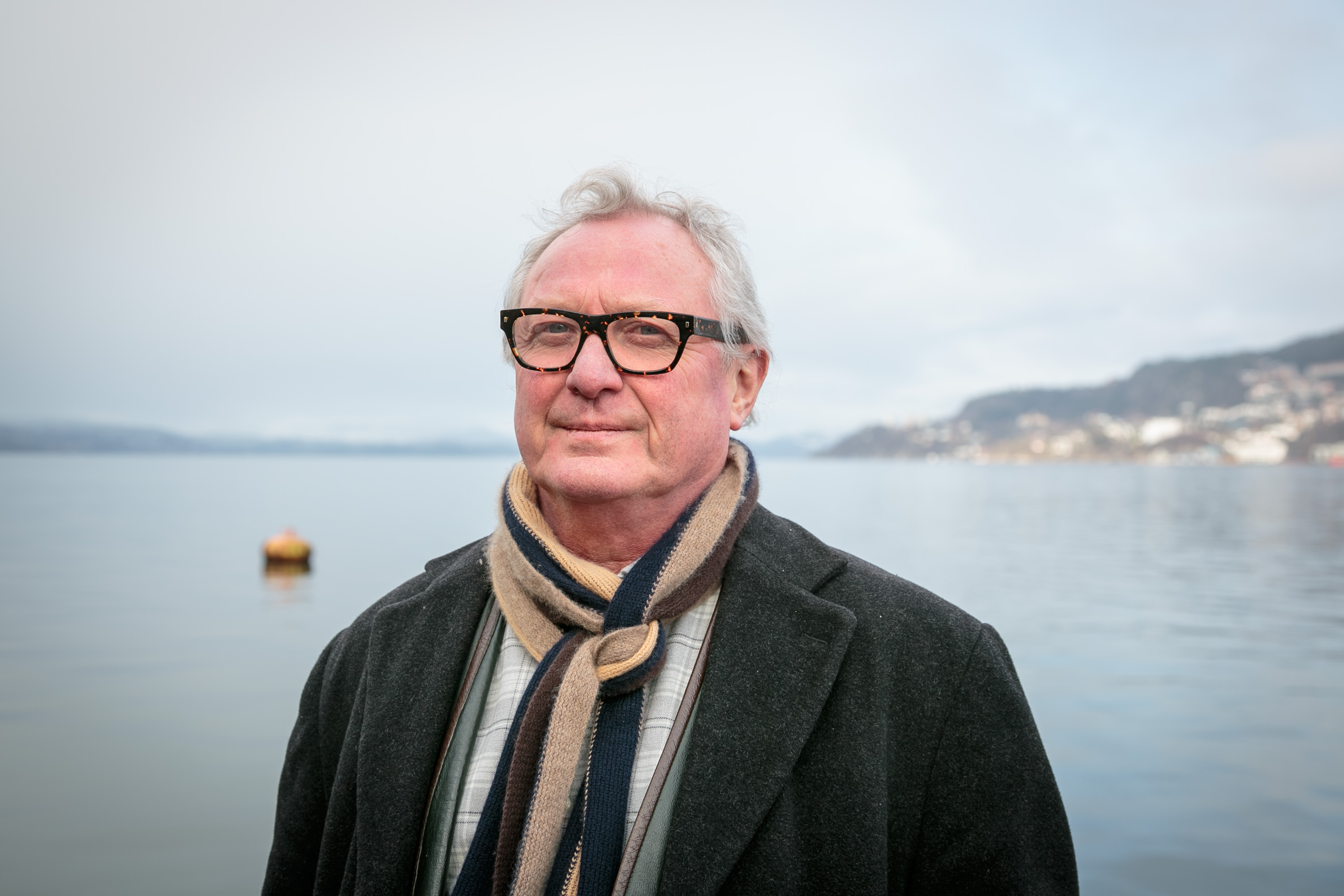 mann ser i kamera, hav bak 