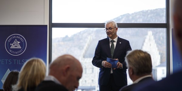 

En mann i dress holder tale