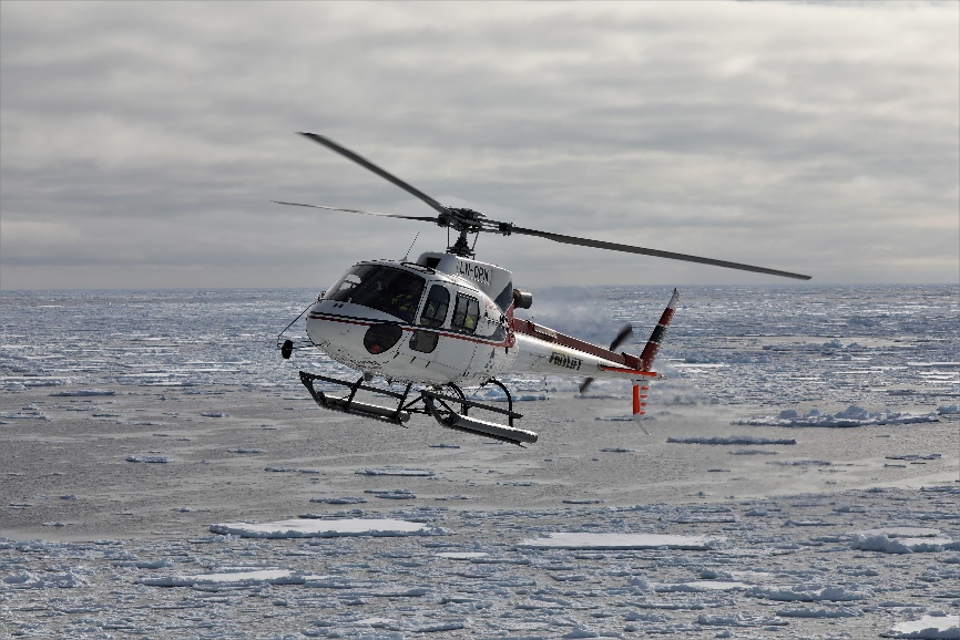 Fig. 2. The helicopter over the Greenland Sea pack ice. (Photo: M. Poltermann)